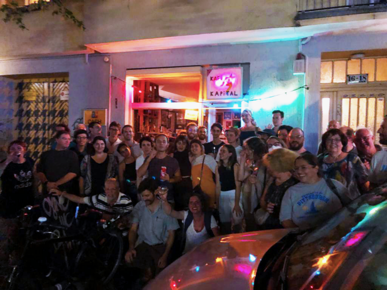 About 40 people posing outside Kapital Bar